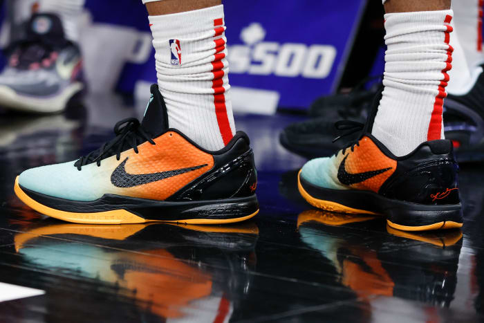 View of black and orange Nike Kobe shoes.